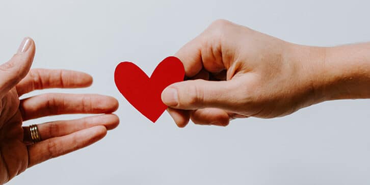 financial giving a heart from hand to hand