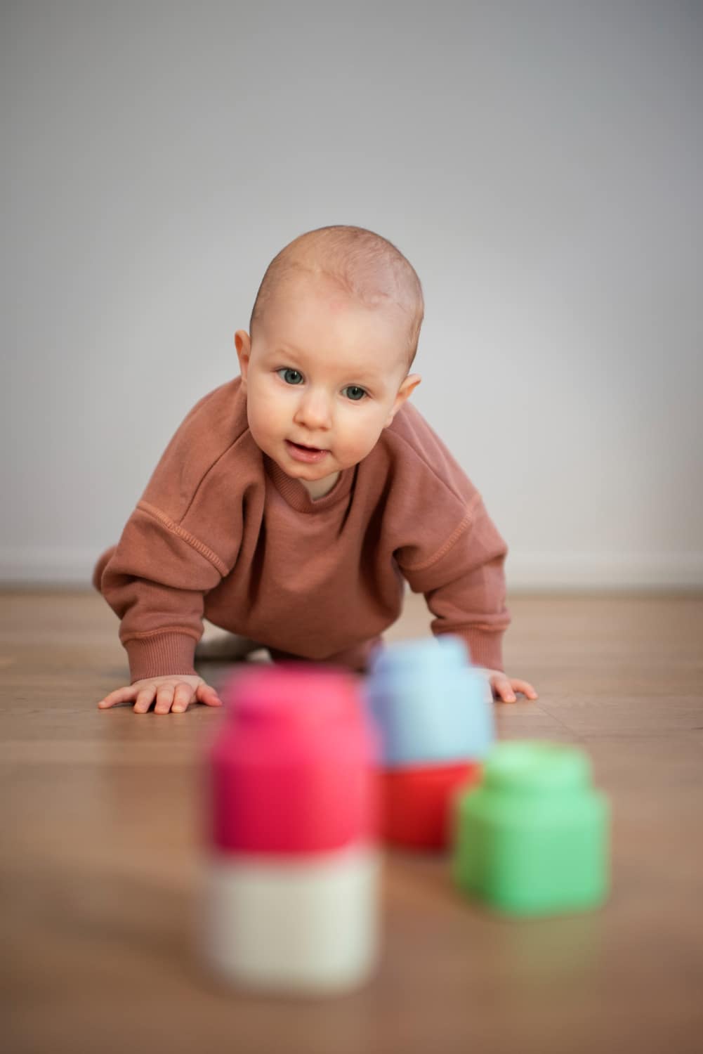 Baby crawls toward building blocks