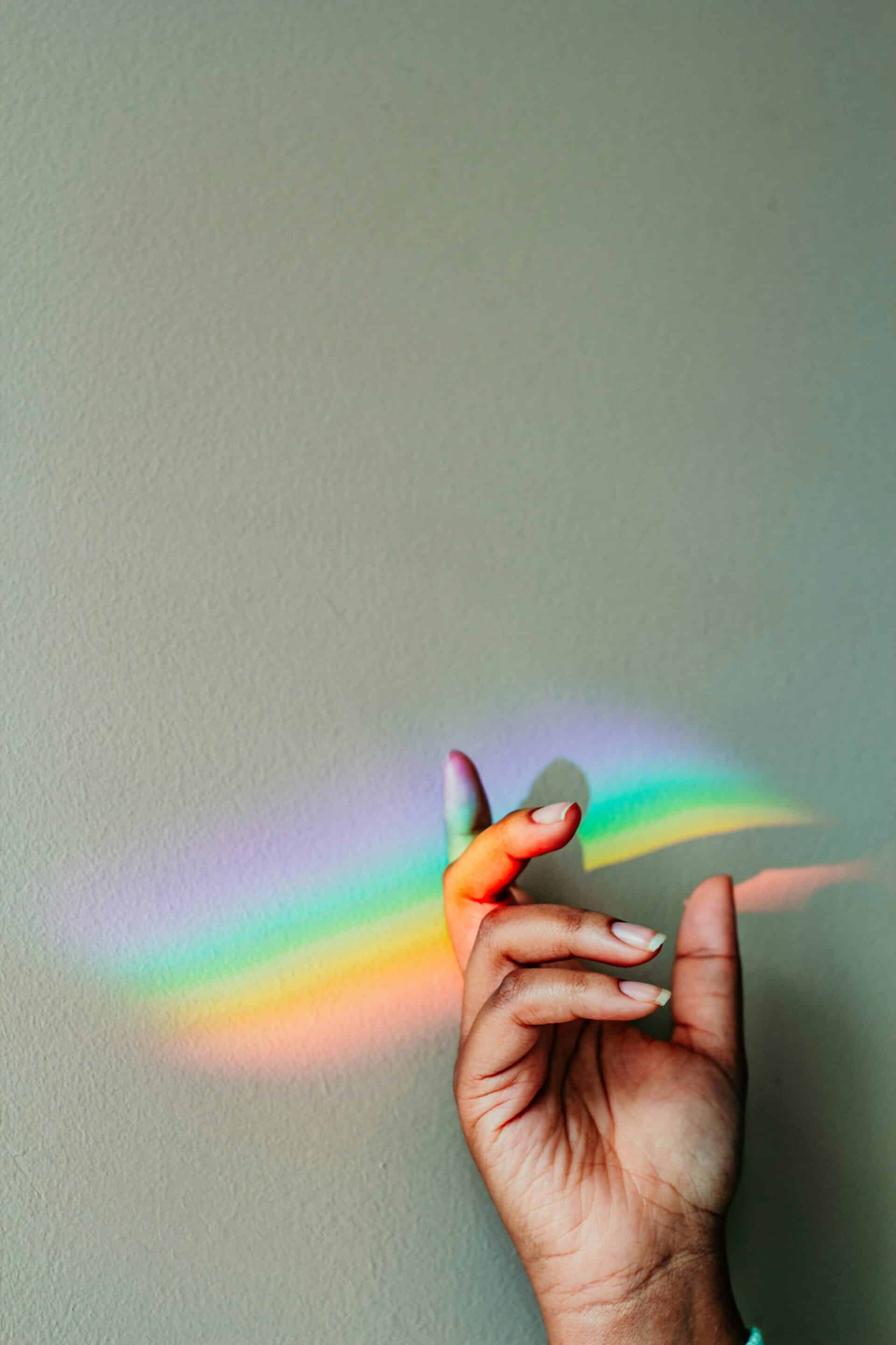 A prism of light is displayed across a hand