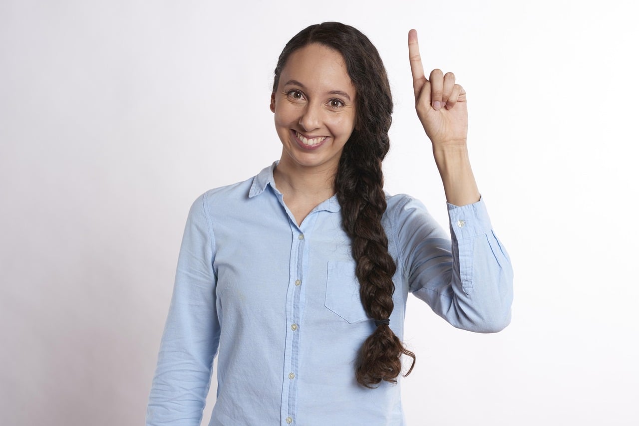 Woman smiling and pointing to sky